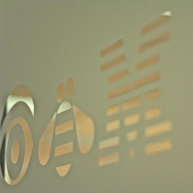 Close-up photo of brass iconography inset into stone