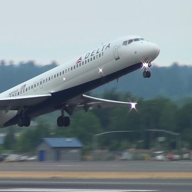 Photo of a passenger airplane taking off over a runway