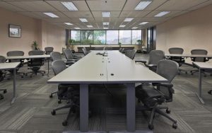 Interior photo of a large workspace with a long conference table